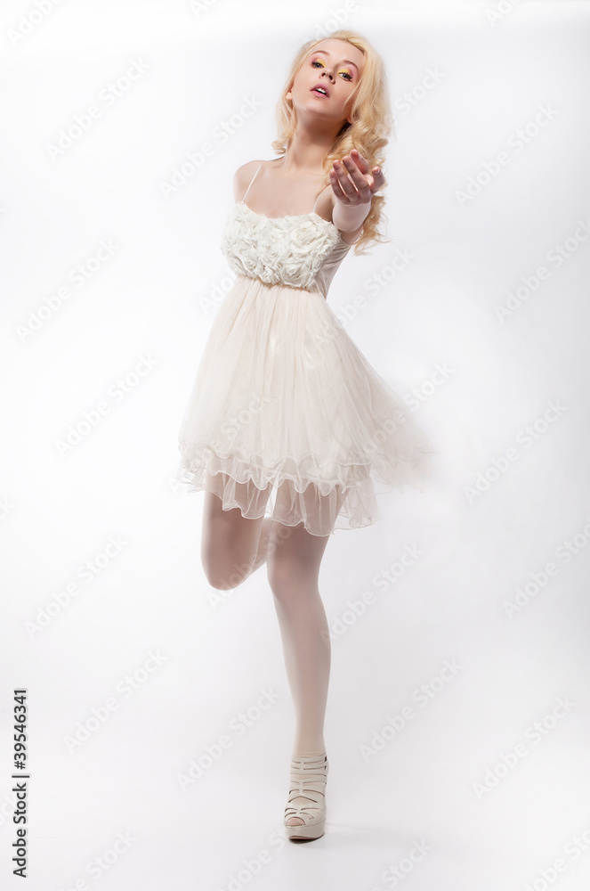 Romantic young pretty woman running in white dress Romantic young pretty woman running in white dress
