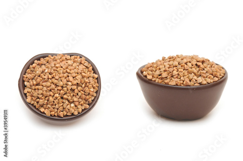 buckwheat in round brown cup isolated on white background