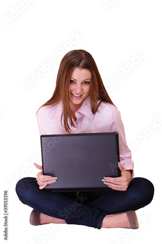 A woman sits with a laptop in the hands of