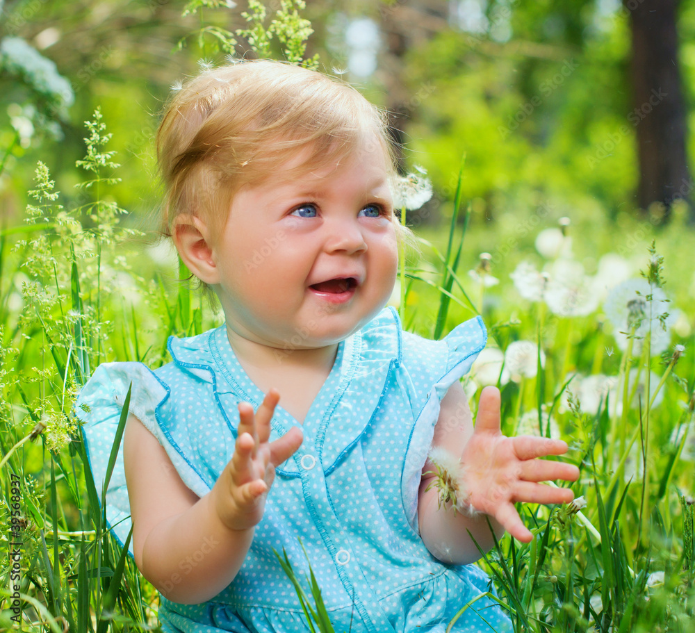 little girl sitting in the grass in the park little girl sitting in the grass in the park