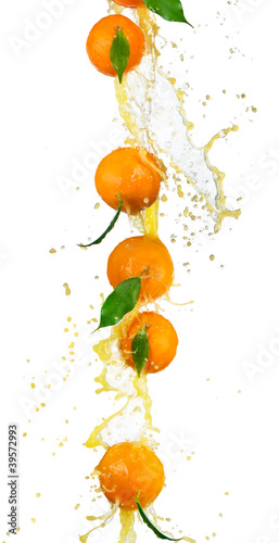 Fresh oranges in juice splash, isolated on white background