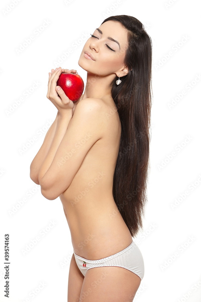 young woman covering her breast with hands with red apple Stock Photo