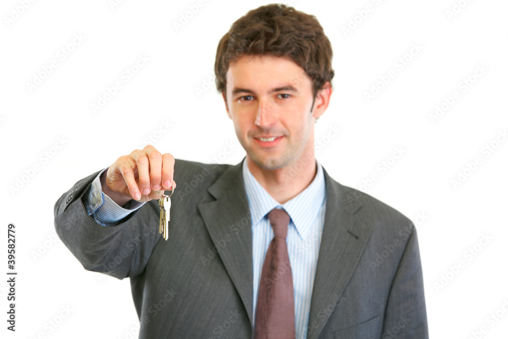 Portrait of happy realtor giving keys Portrait of happy realtor giving keys