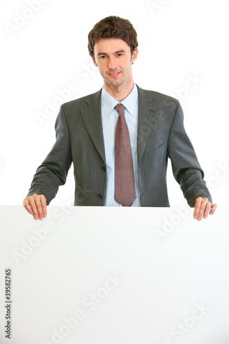 Modern business man showing blank billboard