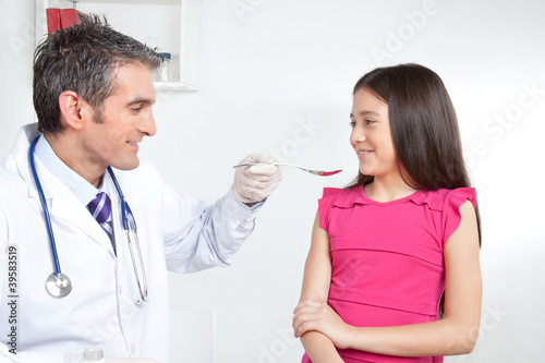 Doctor Giving Medicine to Girl