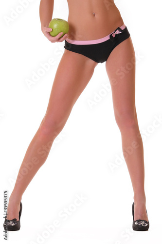 Leggy athletic woman with apple