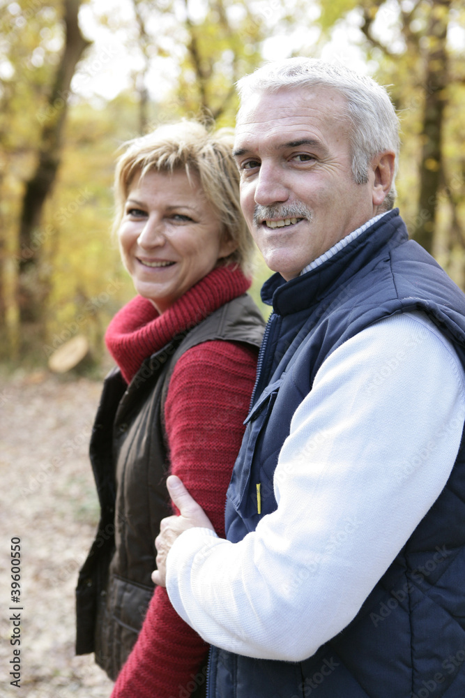 Couple walking through woods