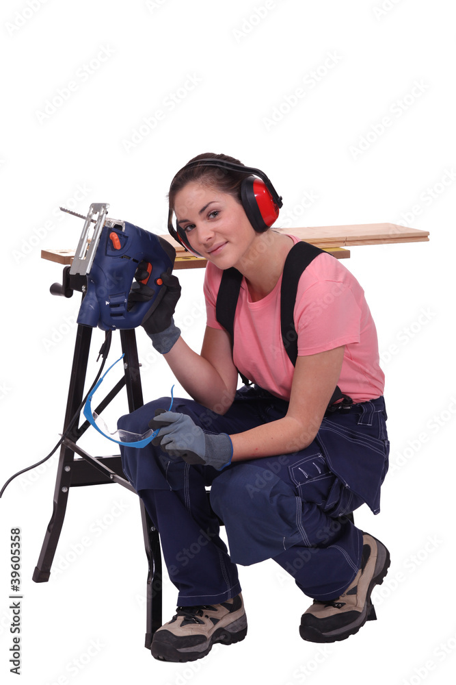 Woman with an electric saw