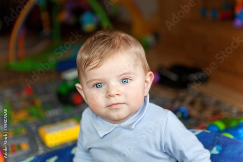 adorable baby boy with blond hairs and blue eyes