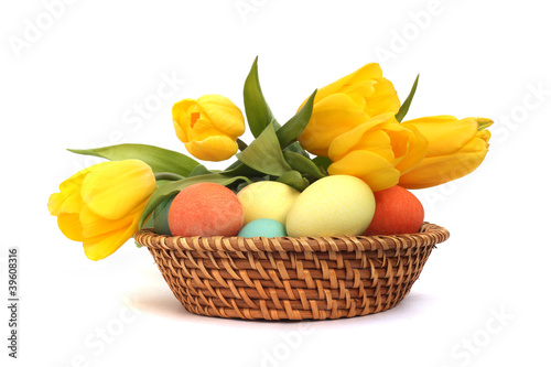 Easter eggs in basket with tulips