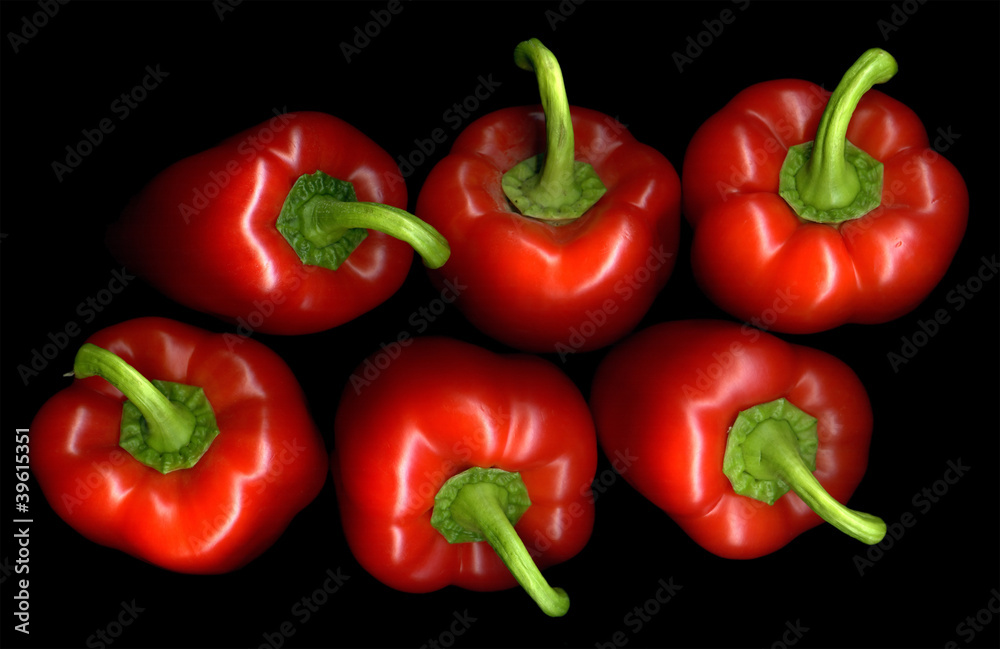 Six red pepper on a black background