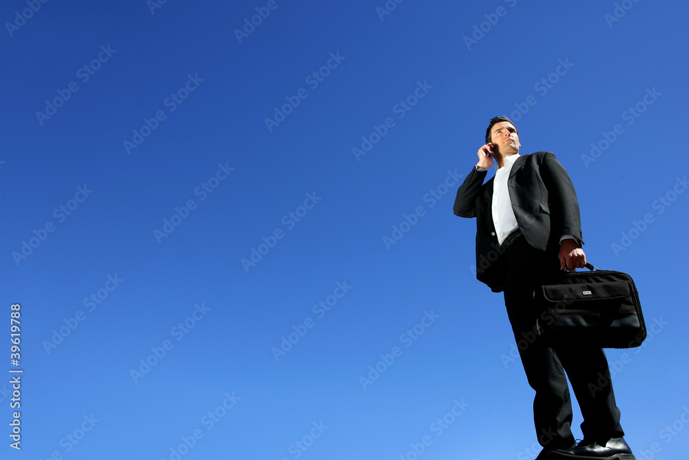 Businessman talking on his mobile phone on a sunny day Businessman talking on his mobile phone on a sunny day
