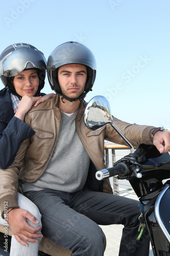 Attractive couple riding scooter