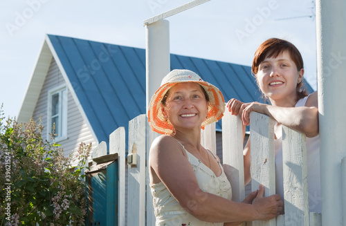 Two women near fence wicket