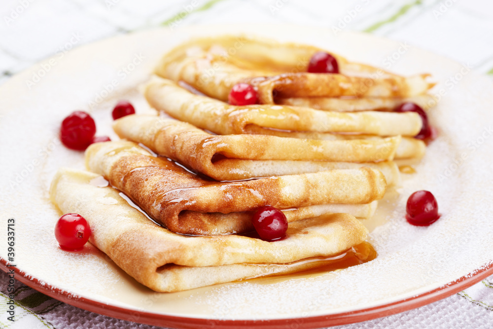 Pancakes with cranberry berries and honey on a plate Pancakes with cranberry berries and honey on a plate