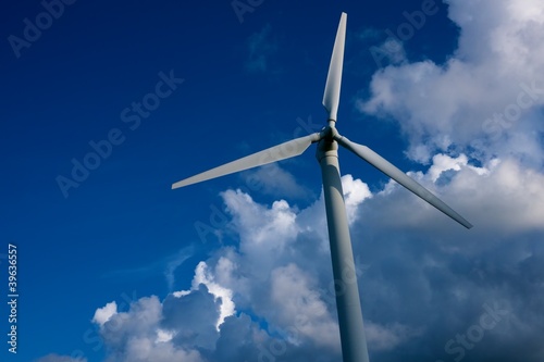 Wind turbine against blue sky.
