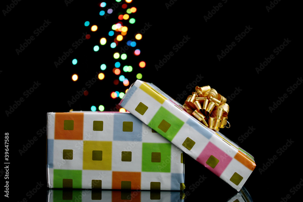 open gift box with bokeh background on black