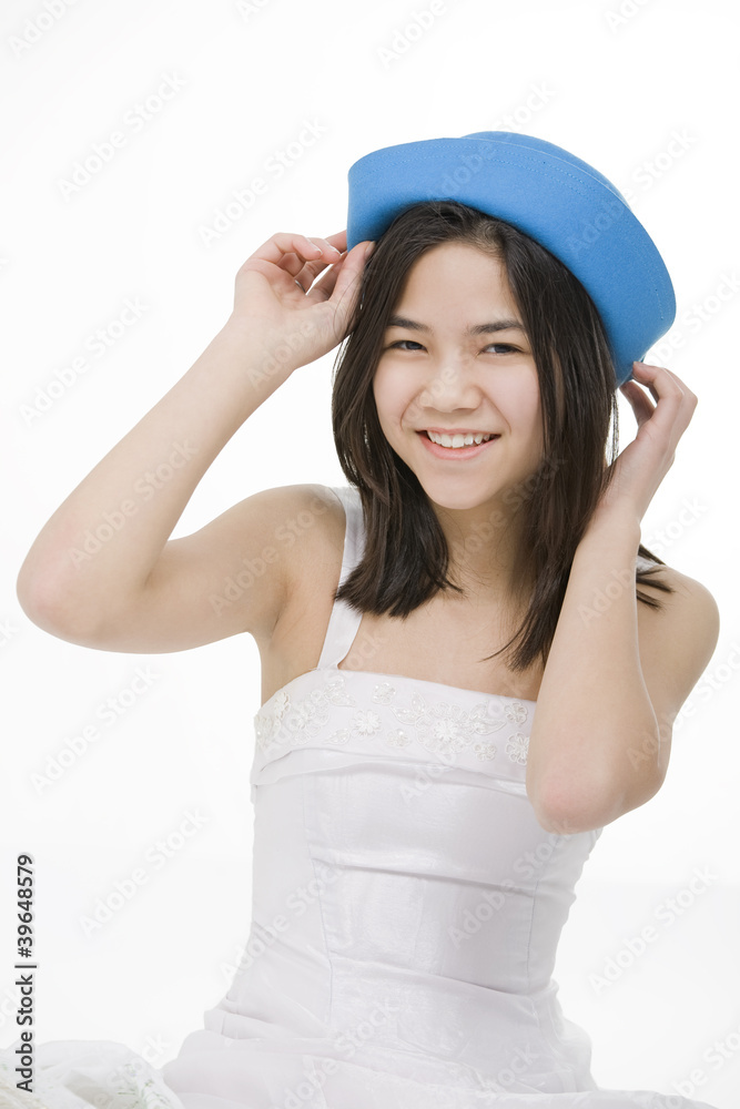 Young smiling biracial teenage girl in blue hat Young smiling biracial teenage girl in blue hat
