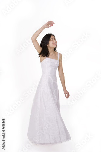 Beautiful young teen girl in white dress , twirling