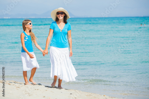 Mother and her daughter having fun on beach