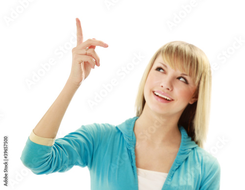 Young smiling woman pointing a hand