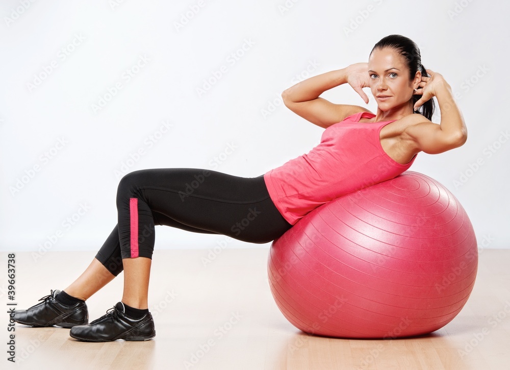 Fototapeta premium Beautiful athlete woman with a fitness ball.