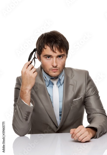 Handsome young man behind desk.