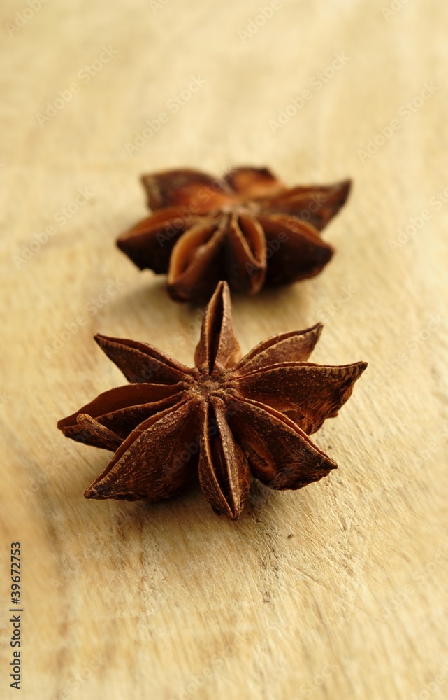 two brown star anise on the board