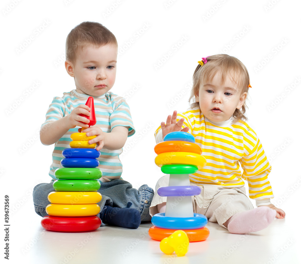 two little children playing with color toys two little children playing with color toys