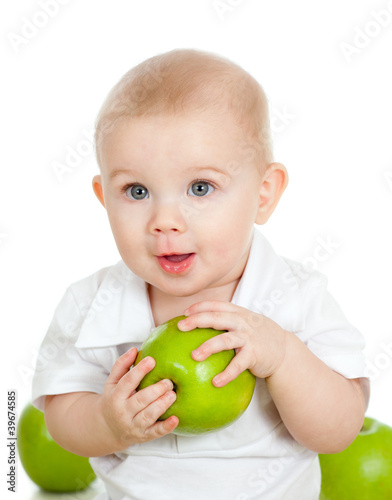 Baby boy holding and eating...