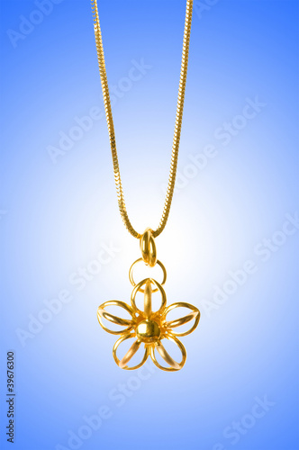 Golden jewellery against gradient background