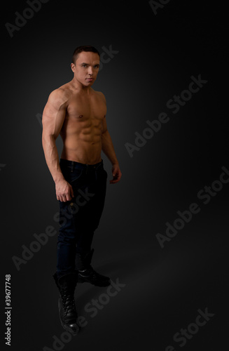 Sexy naked torso fit and neat young man studio full portrait