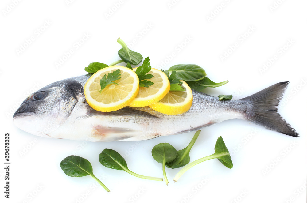 Fresh fish with lemon and parsley isolated on white.