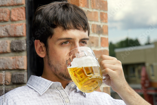 Young guy drinking beer