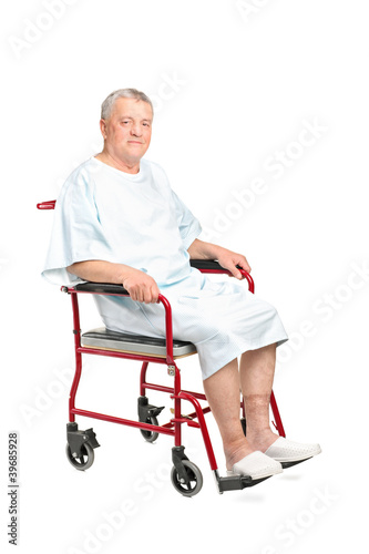 A senior patient seated in a wheelchair posing