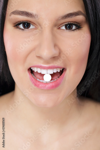 Close-up of pill in woman's mouth