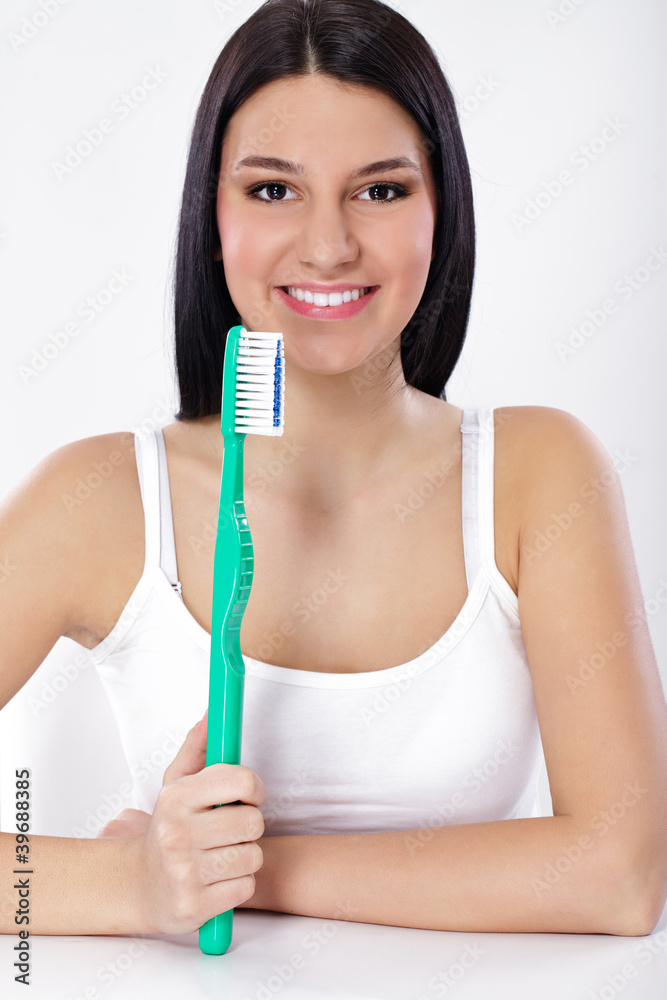 Beautiful woman holding big toothbrush Beautiful woman holding big toothbrush
