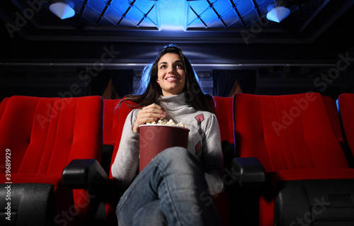 watching a movie at the cinema: portrait of a pretty girl