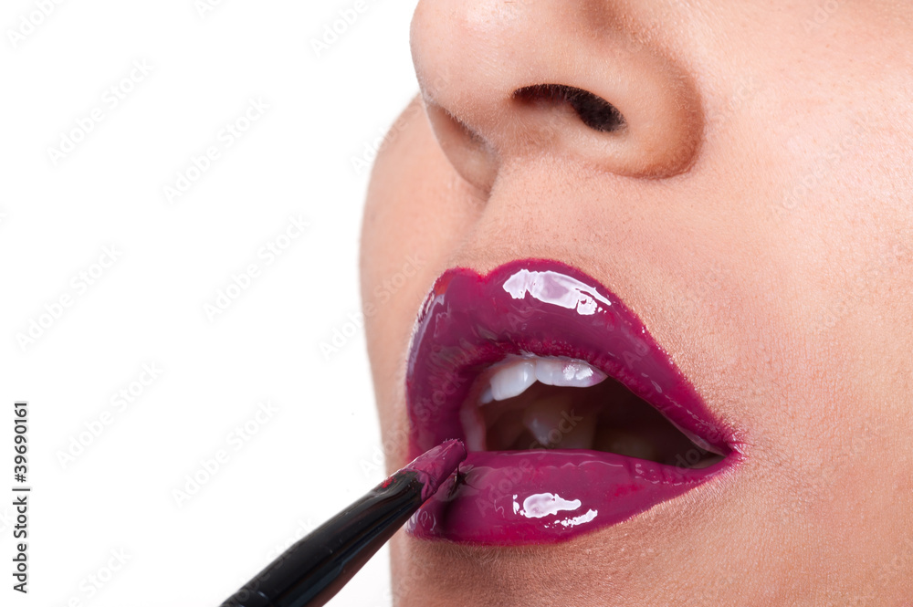 Naklejka premium Close up of glossy red bright lips application.
