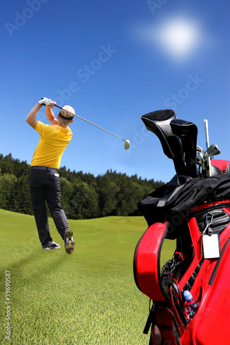 Man playing golf with golf bag