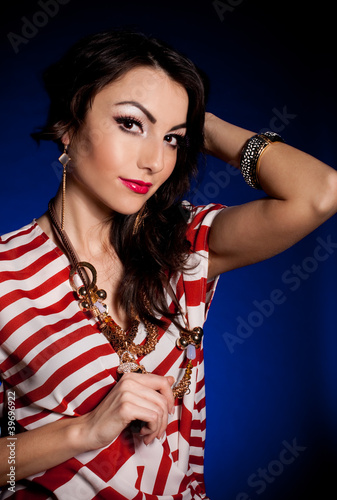 Beautiful woman in retro dress with golden jewelry