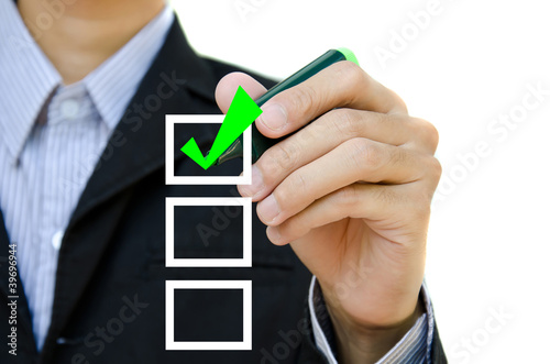 Young business hand with pen mark the check boxes.