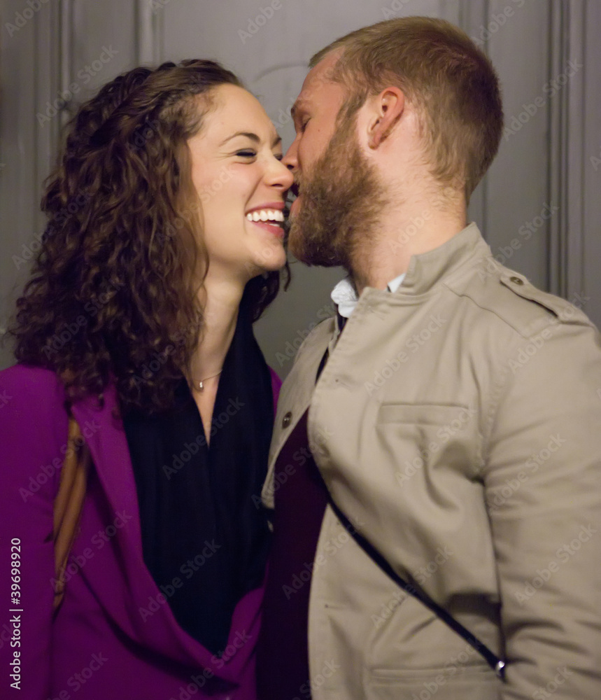 Young couple in the dark hallway kissing and laughing. Young couple in the dark hallway kissing and laughing.