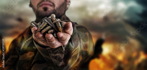 Photos army war concept , military warrior with a handful of bullets ag