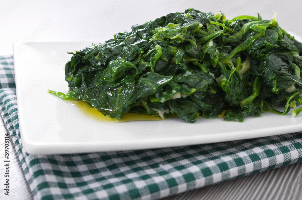 Boiled spinach on white dish. Spinaci bolliti. Boiled spinach on white dish. Spinaci bolliti.