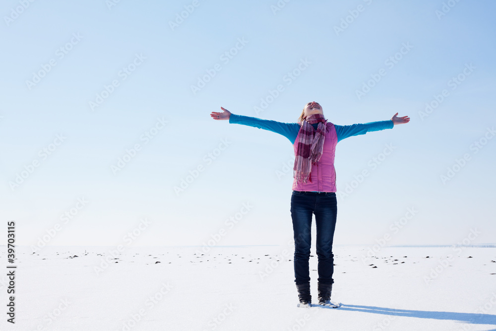 Teen girl staying with raised hands