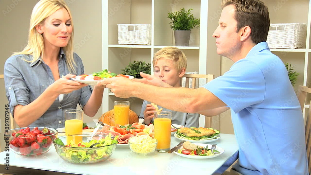 Young Caucasian Family Eating Healthy Lunch Together Young Caucasian Family Eating Healthy Lunch Together
