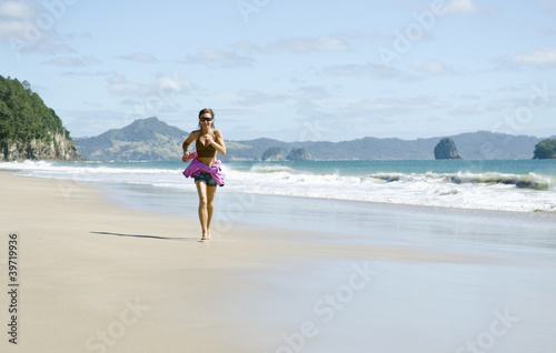 woman jogging along a beautiful beach.