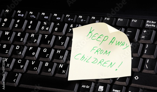 keyboard with 'keep away from children' on it.