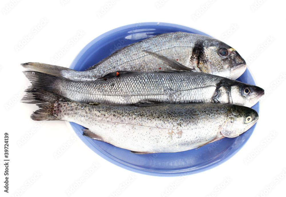 Fresh fishes on plate isolated on white Fresh fishes on plate isolated on white